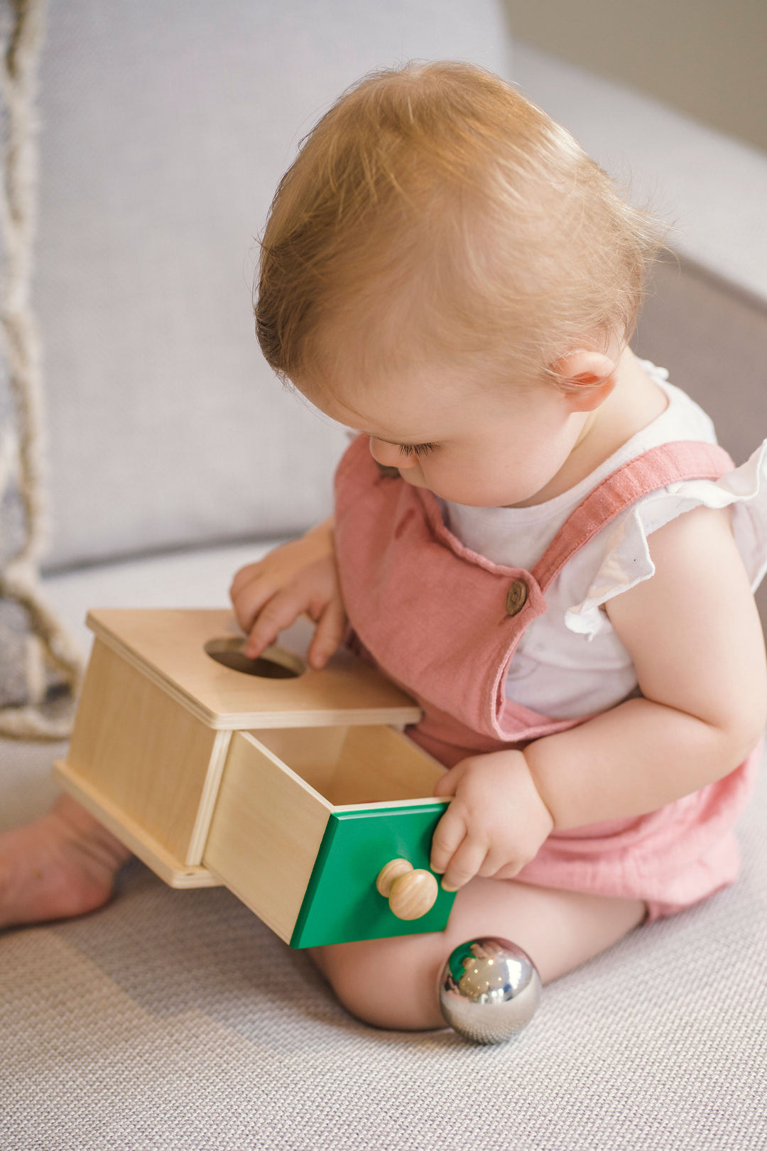 Baby playing with Object Permanence box - great for cognitive development 