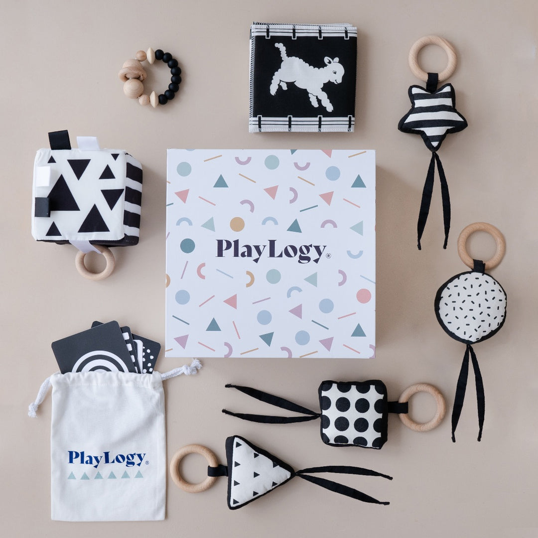 Newborn play box with black and white sensory toys that promote brain development
