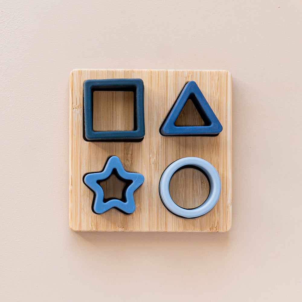 Silicone shape sorter puzzle toy in different shades of blue.