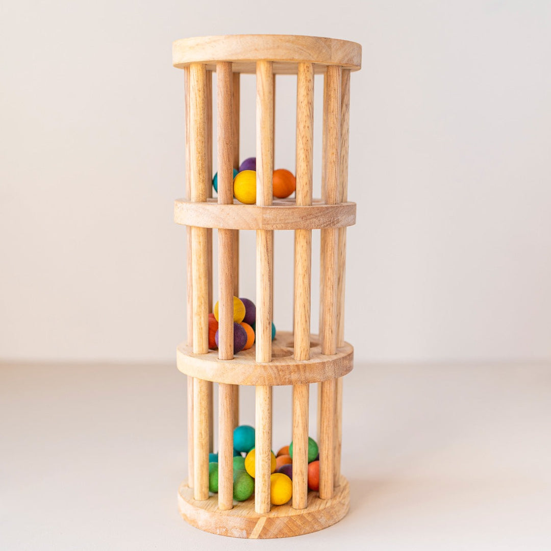 Wooden Rain Maker toy with coloured beads inside.