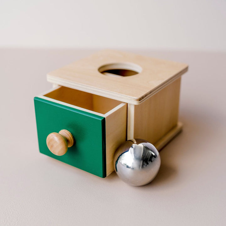 Box and Ball Drop toy to teach object permanence and pincer grip development.
